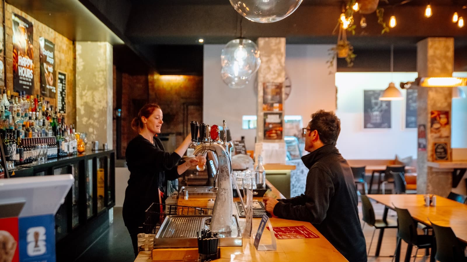 Staff serving a customer at the Biddy Kate's bar
