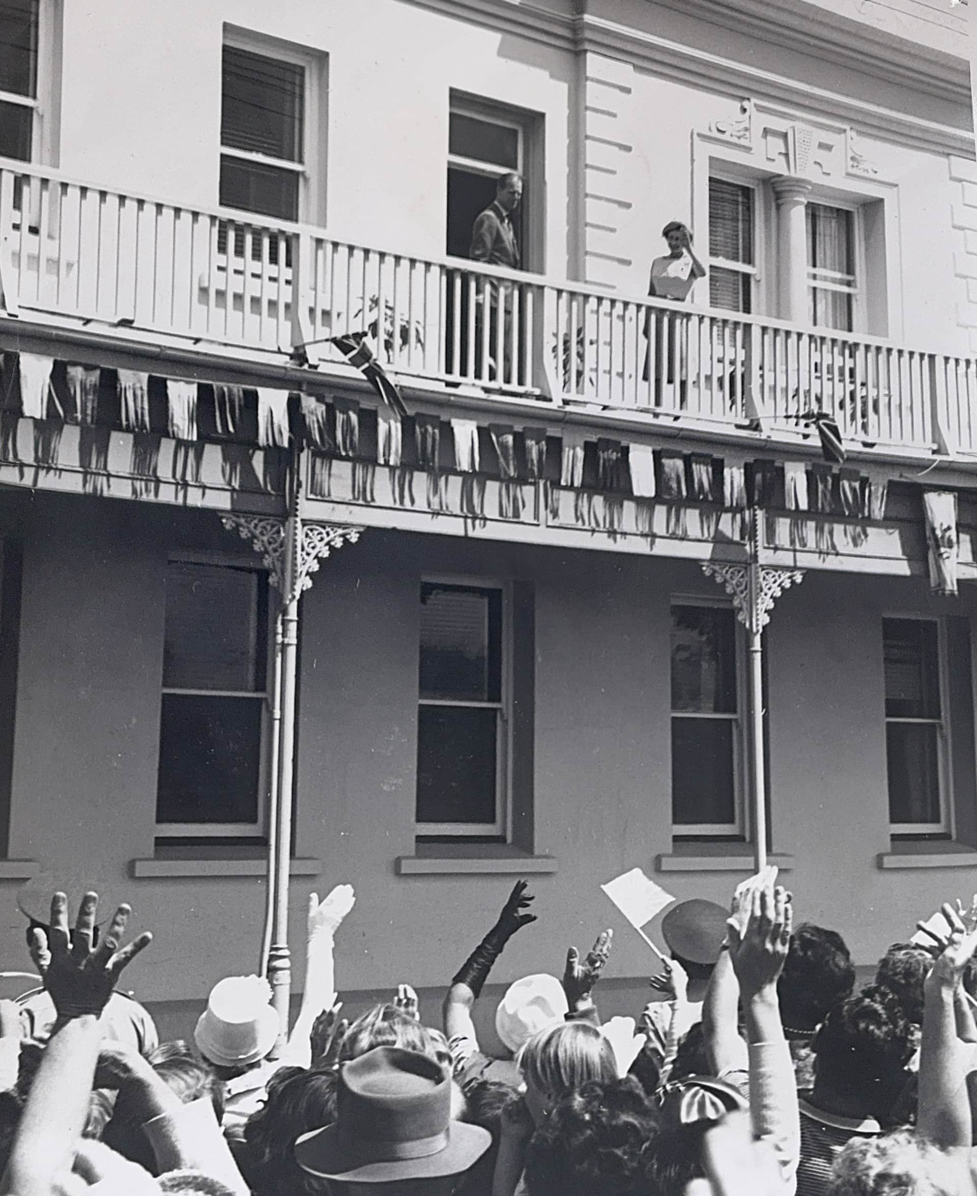 Queen Elizabeth II and the Duke of Edinburgh on the balcony of the Criterion Hotel, Blenheim, February 1963, greeted by a large crowd